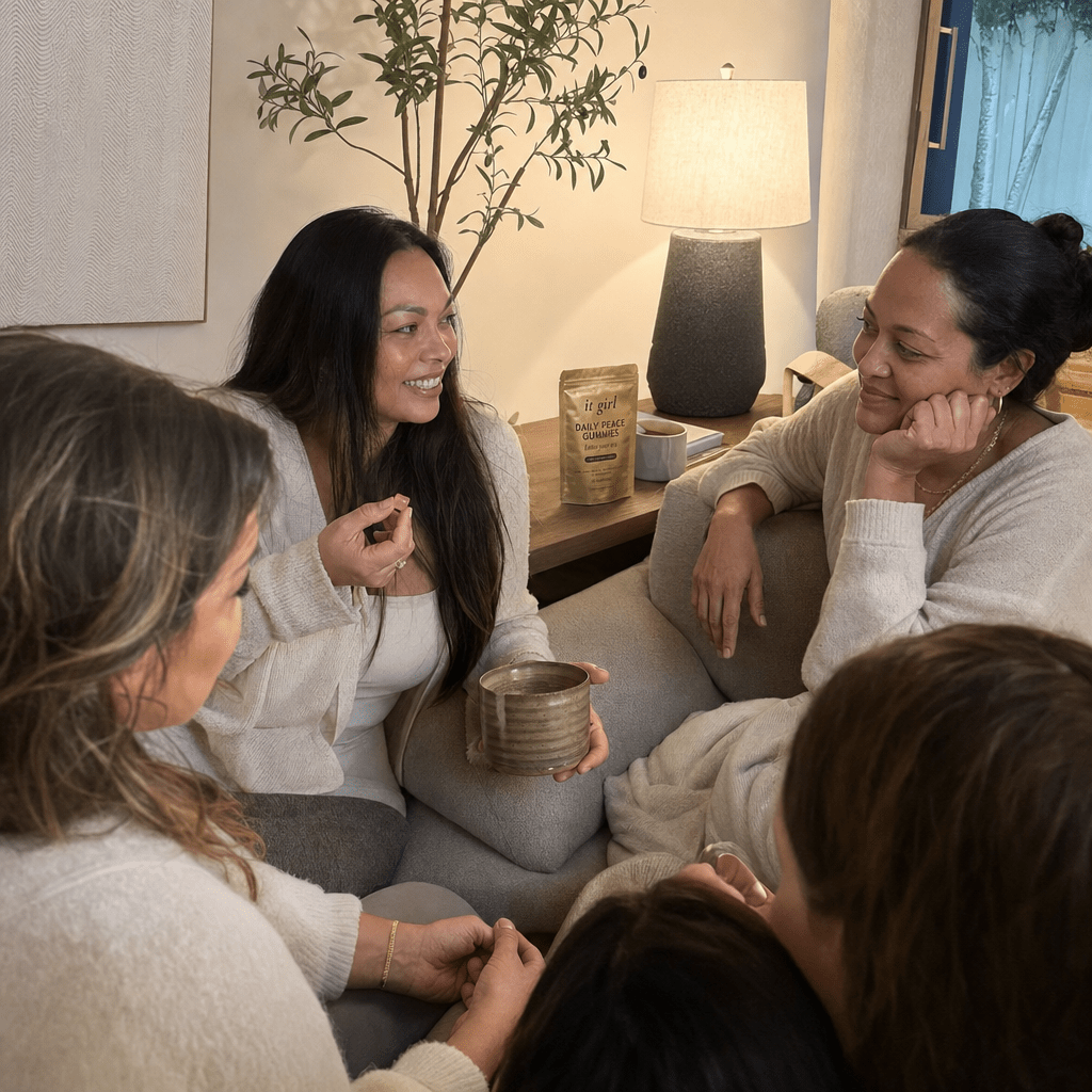 Several real mothers together in warm evening light, at ease, each with the Daily Peace pouch subtly present, the my-family-noticed beat