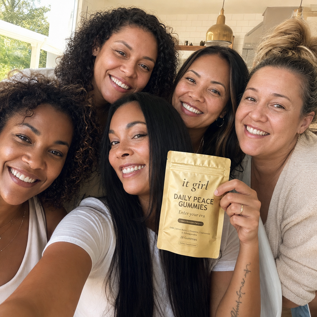 A warm group selfie of five everyday women laughing together, one holding up the gold It Girl Daily Peace pouch