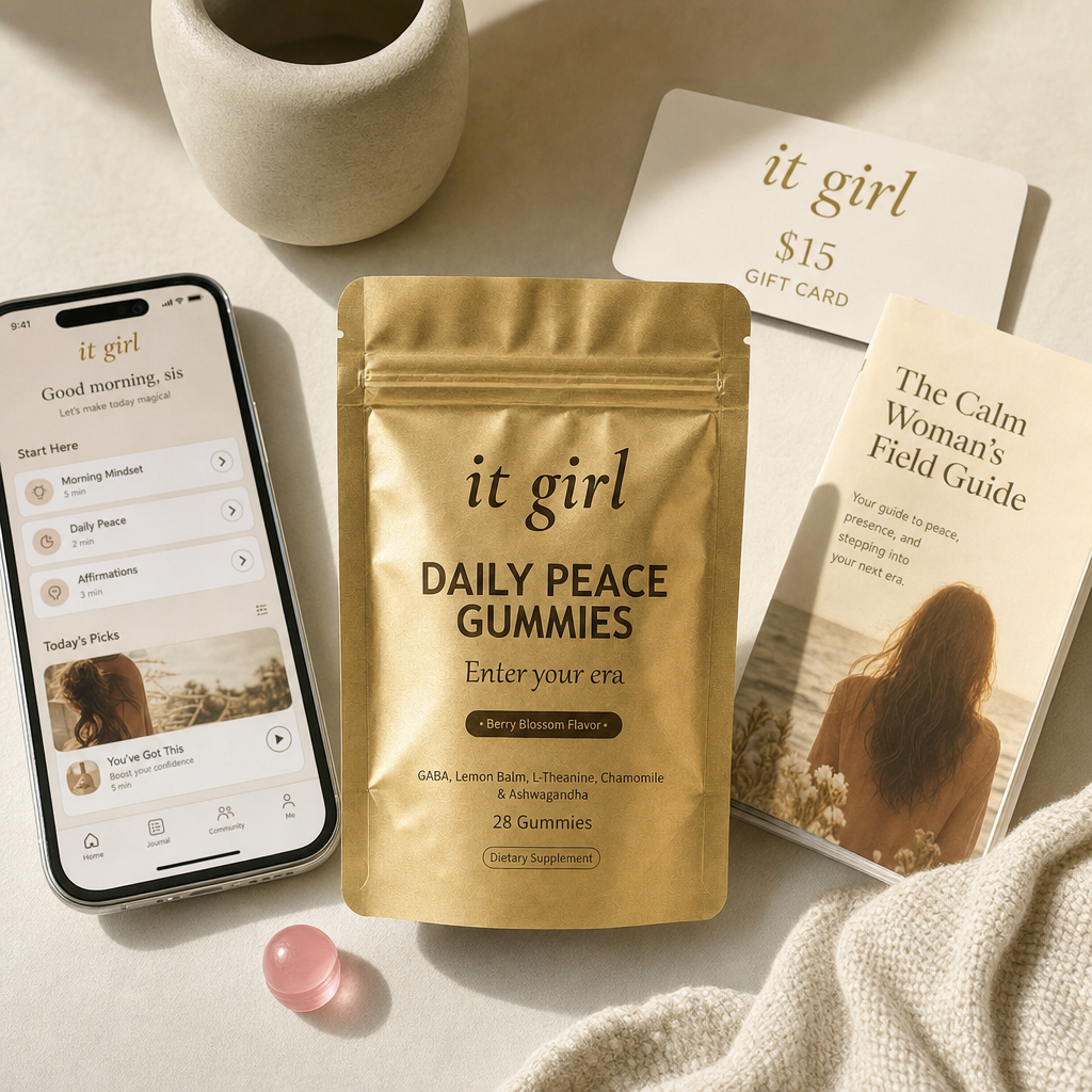 Daily Peace bundle on cream, the gold pouch, the It Girl app on a phone, a fifteen dollar gift card, the Calm Woman's Field Guide booklet and a warm-clay price and guarantee badge, no wine