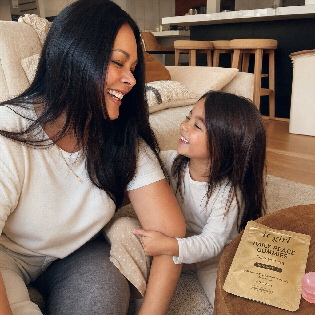 A mom present and laughing with her young child, the It Girl Daily Peace pouch on a side table