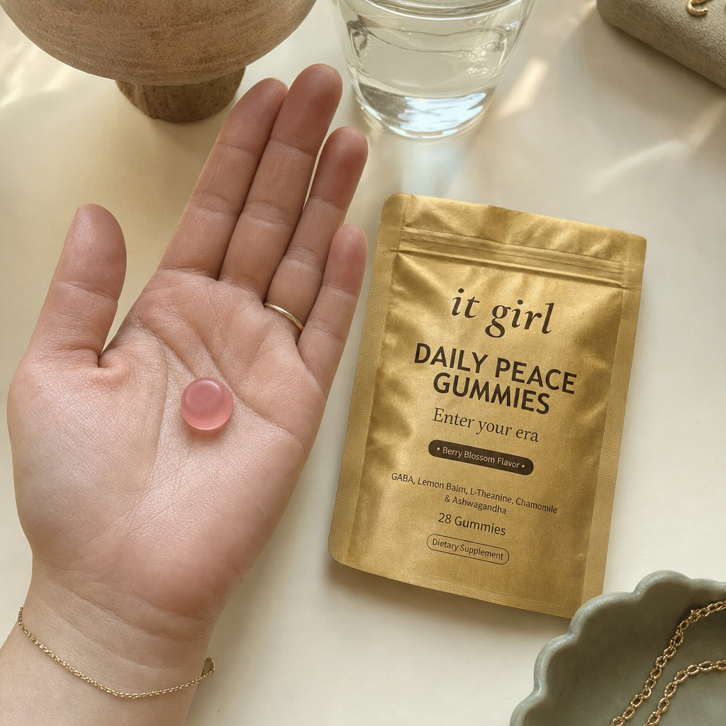 Open palm with a single Daily Peace gummy beside the pouch and a glass of water, GABA plus L-Theanine, the signal without the drink