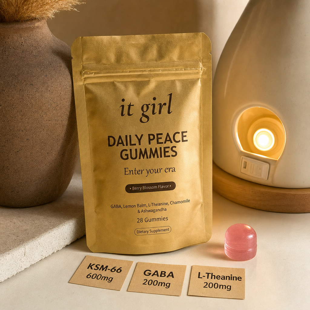 The real matte-gold It Girl Daily Peace pouch with a single pink gummy and three dose cards reading KSM-66 600mg, GABA 200mg, L-Theanine 200mg on a warm cream surface, the molecule that reaches the same receptor without the 3am cost