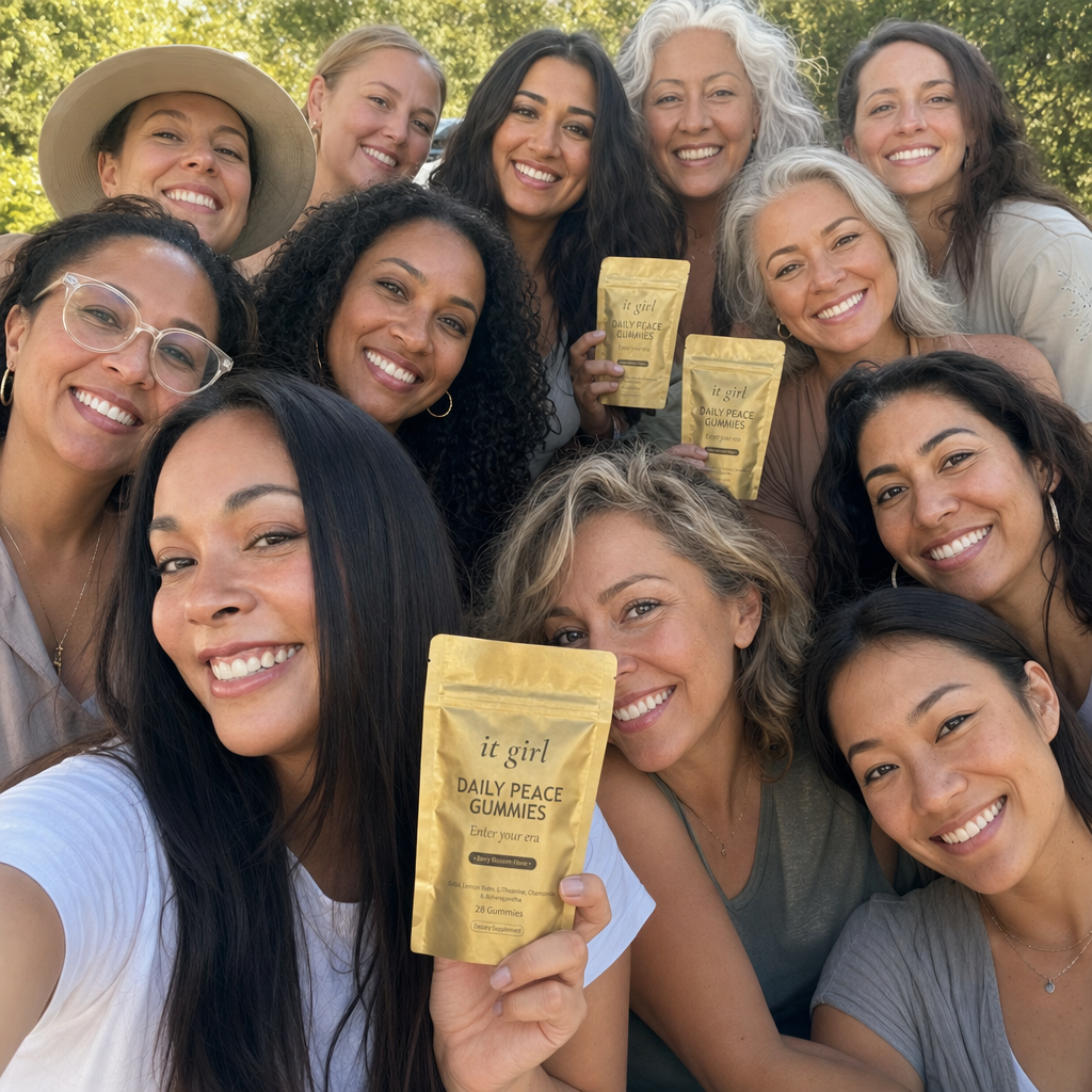 A real group selfie of a dozen happy everyday women together outdoors, several holding the gold It Girl Daily Peace pouch, the 9,000-plus women it has helped