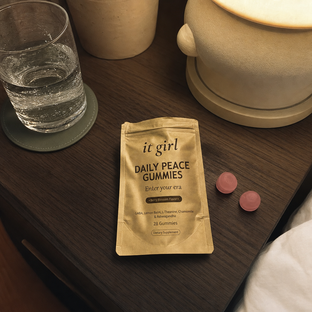 The real gold It Girl Daily Peace pouch opened on a warm evening nightstand beside a berry-blossom gummy and a glass of water, the drained calm brake handed back