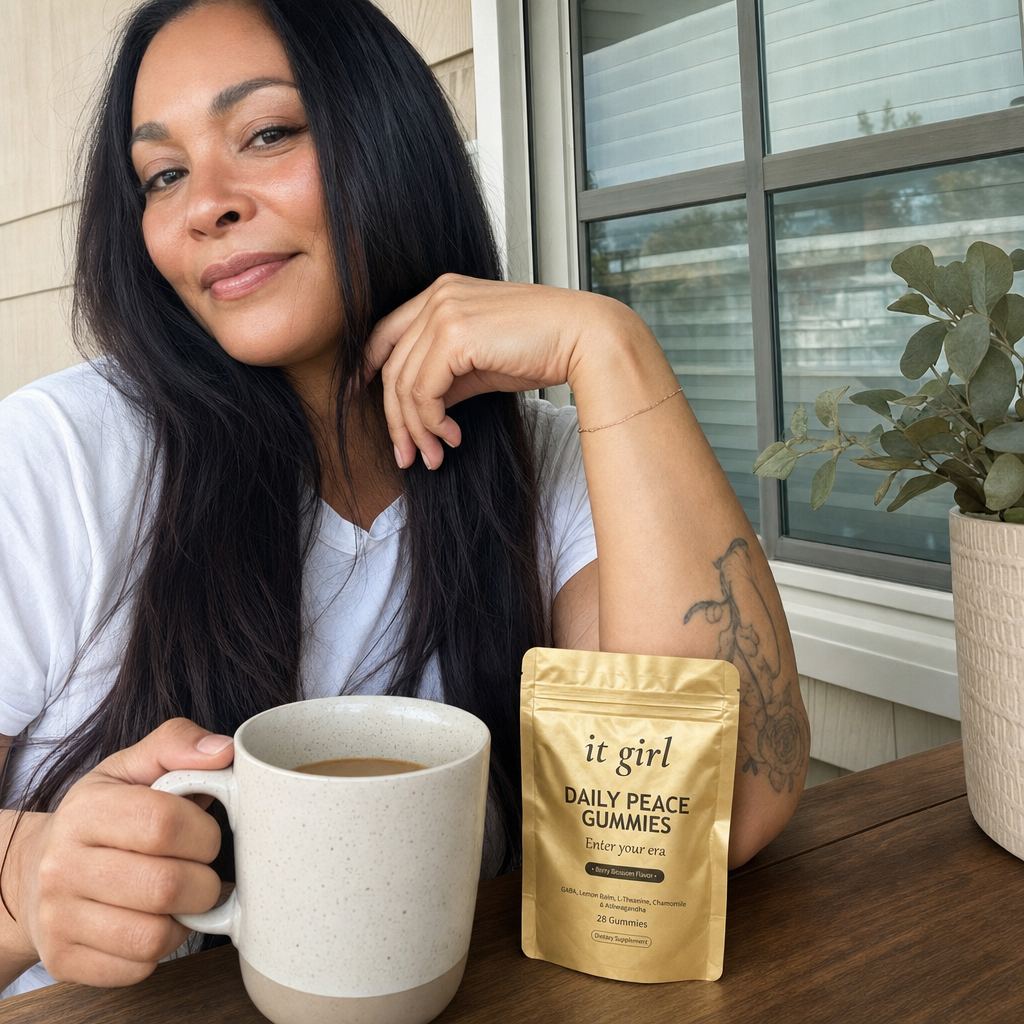 A woman calm and in command on a sunlit porch with a mug of coffee, the gold Daily Peace pouch resting nearby