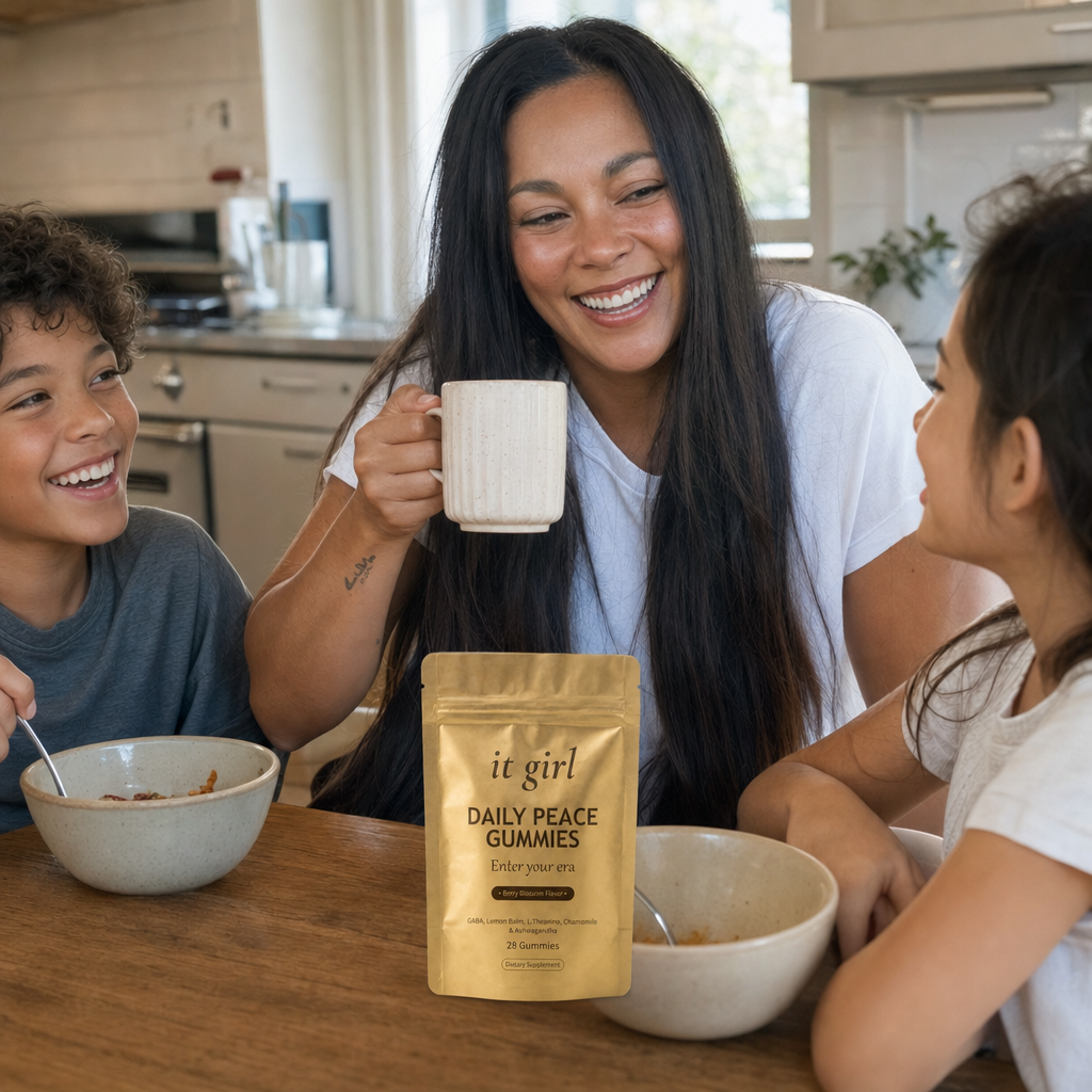 A mom fully present with her kids at a sunlit breakfast table, the It Girl Daily Peace pouch on the counter