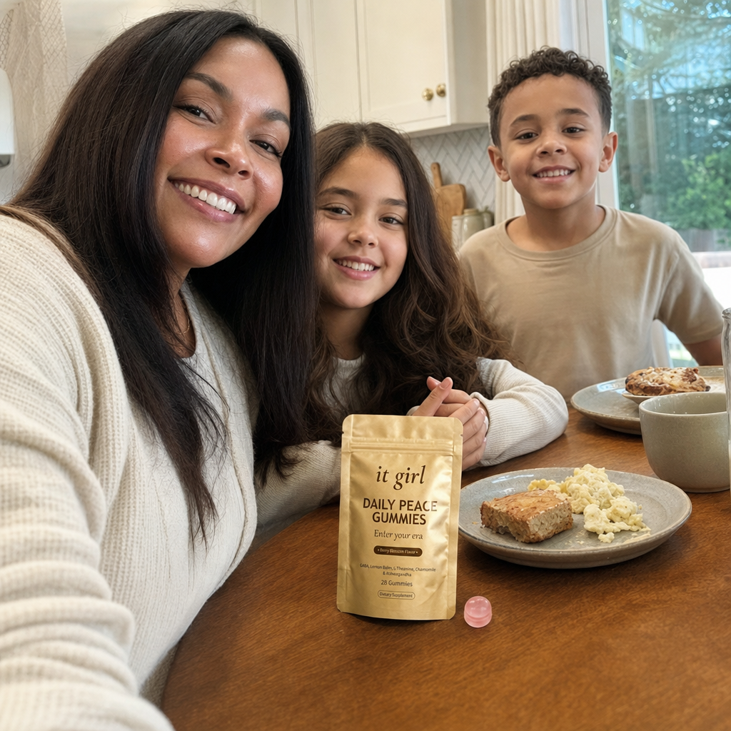 A mom fully present with her kids at a sunlit breakfast table, the It Girl Daily Peace pouch on the counter