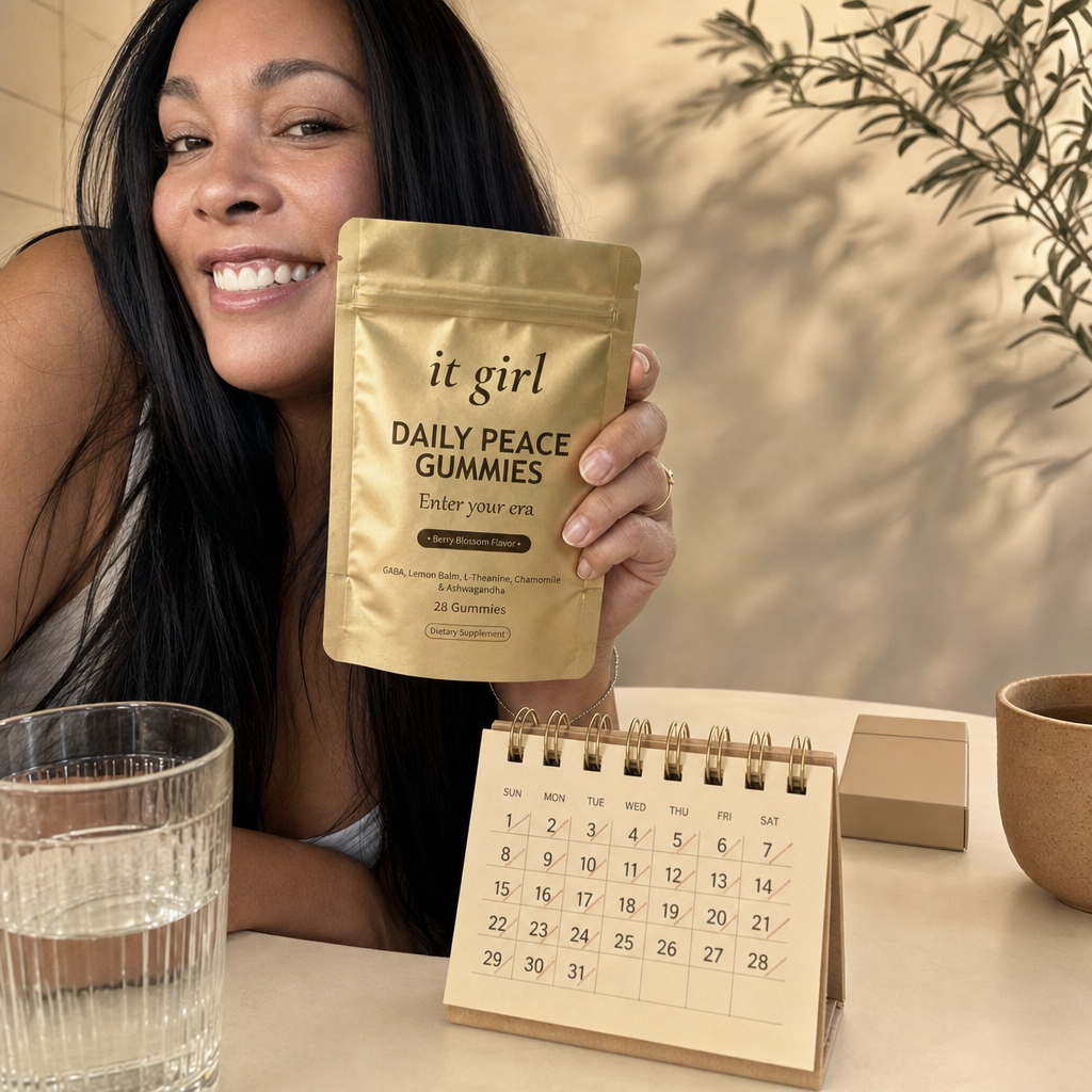 The palm-sized gold It Girl Daily Peace pouch and a month calendar in sharp focus on a cream surface, one plain unbranded cigarette pack soft-focused behind them, a whole month of calm for less than the habit costs