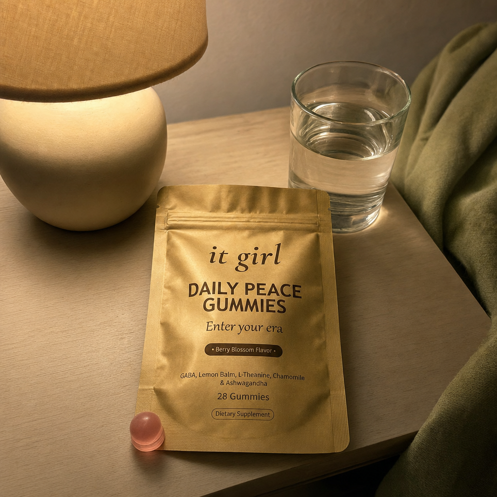Daily Peace pouch on a nightstand at dusk under a warm lamp, the cortisol layer easing, KSM-66 600mg