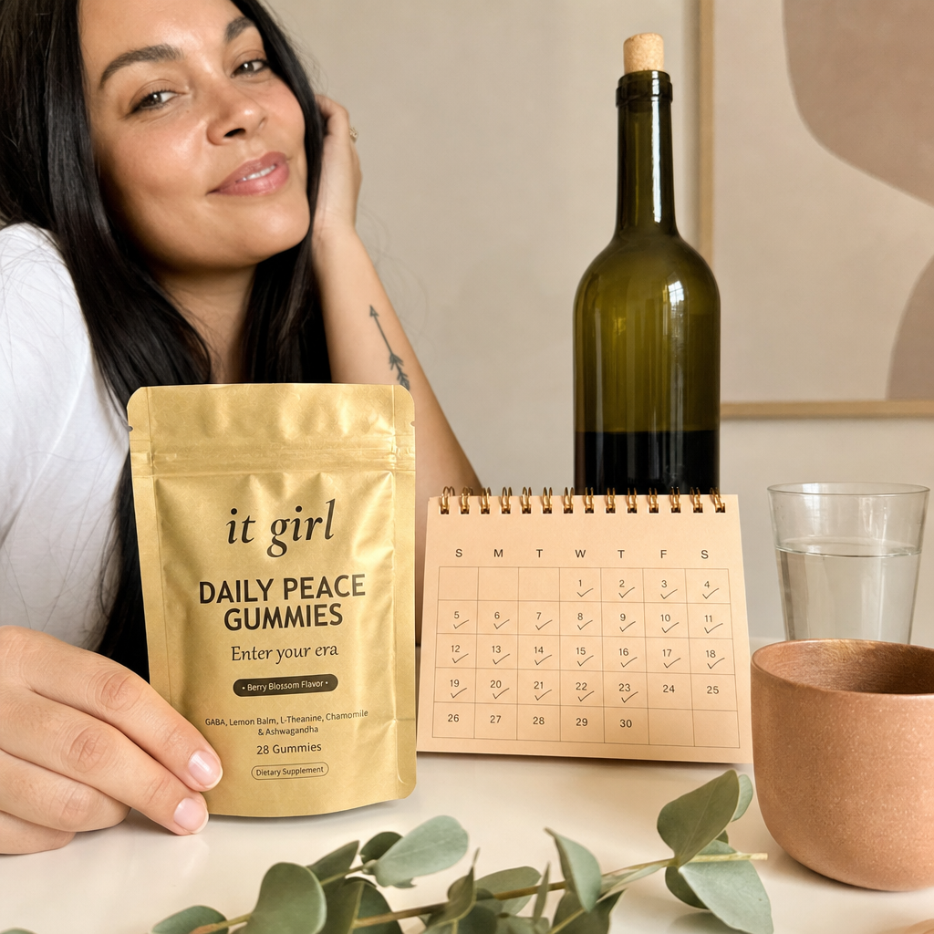 The palm-sized gold It Girl Daily Peace pouch and a month calendar beside one bottle of wine, a whole month of calm for less than one bottle