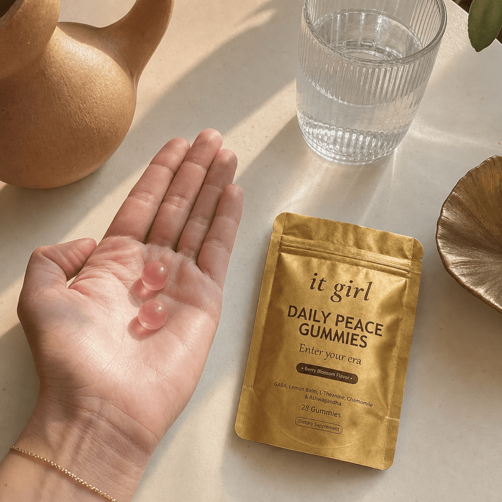 Open palm holding two Daily Peace gummies beside the pouch and a glass of water, the GABA plus L-Theanine signal