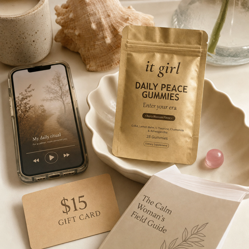 The Daily Peace bundle on cream: gold pouch, the It Girl app on a phone, a $15 gift card and the Calm Woman's Field Guide.