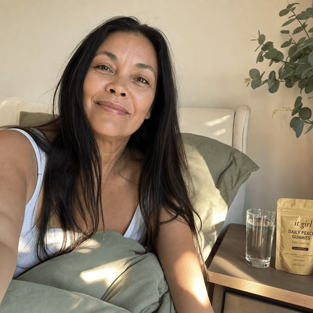 A woman waking clear and rested in soft morning light with the gold Daily Peace pouch on her nightstand, no foggy wine morning