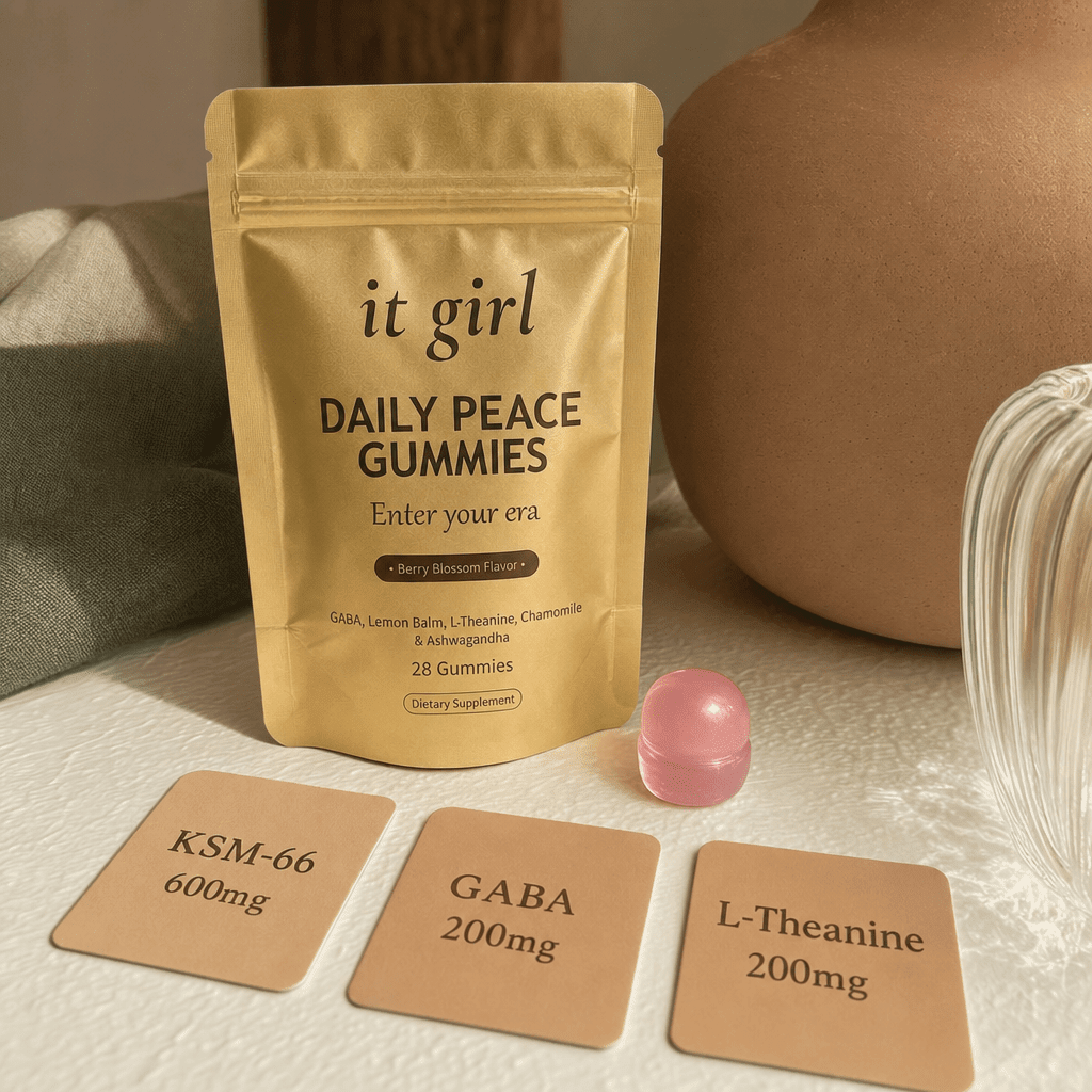 A single pink Daily Peace gummy beside three dose cards reading KSM-66 600mg, GABA 200mg, L-Theanine 200mg, with the gold pouch behind them, the studied dose