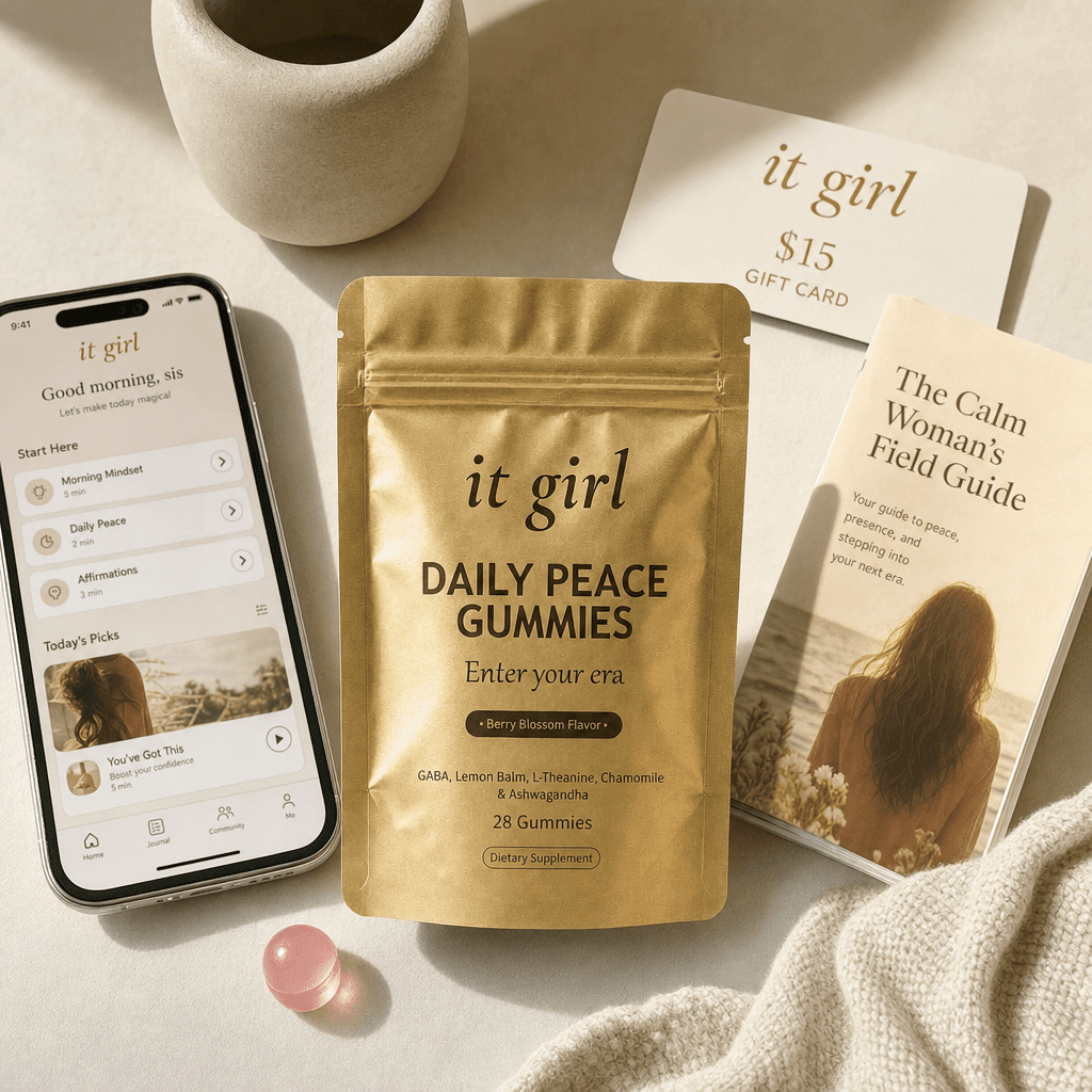 Daily Peace bundle on cream, the gold pouch, the It Girl app on a phone, a fifteen dollar gift card, the Calm Woman's Field Guide booklet and a warm-clay price and guarantee badge, no wine
