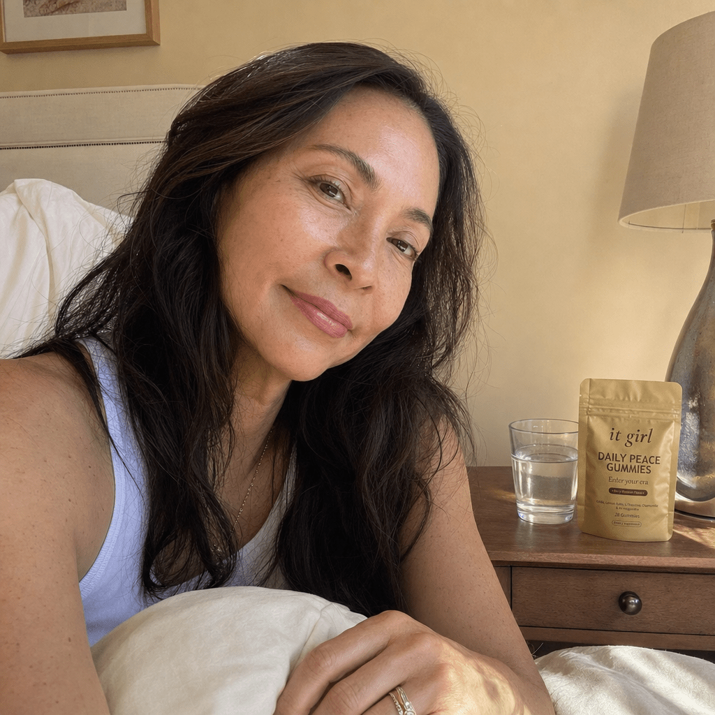 A woman waking clear and rested in soft morning light with the gold Daily Peace pouch on her nightstand, no foggy wine morning