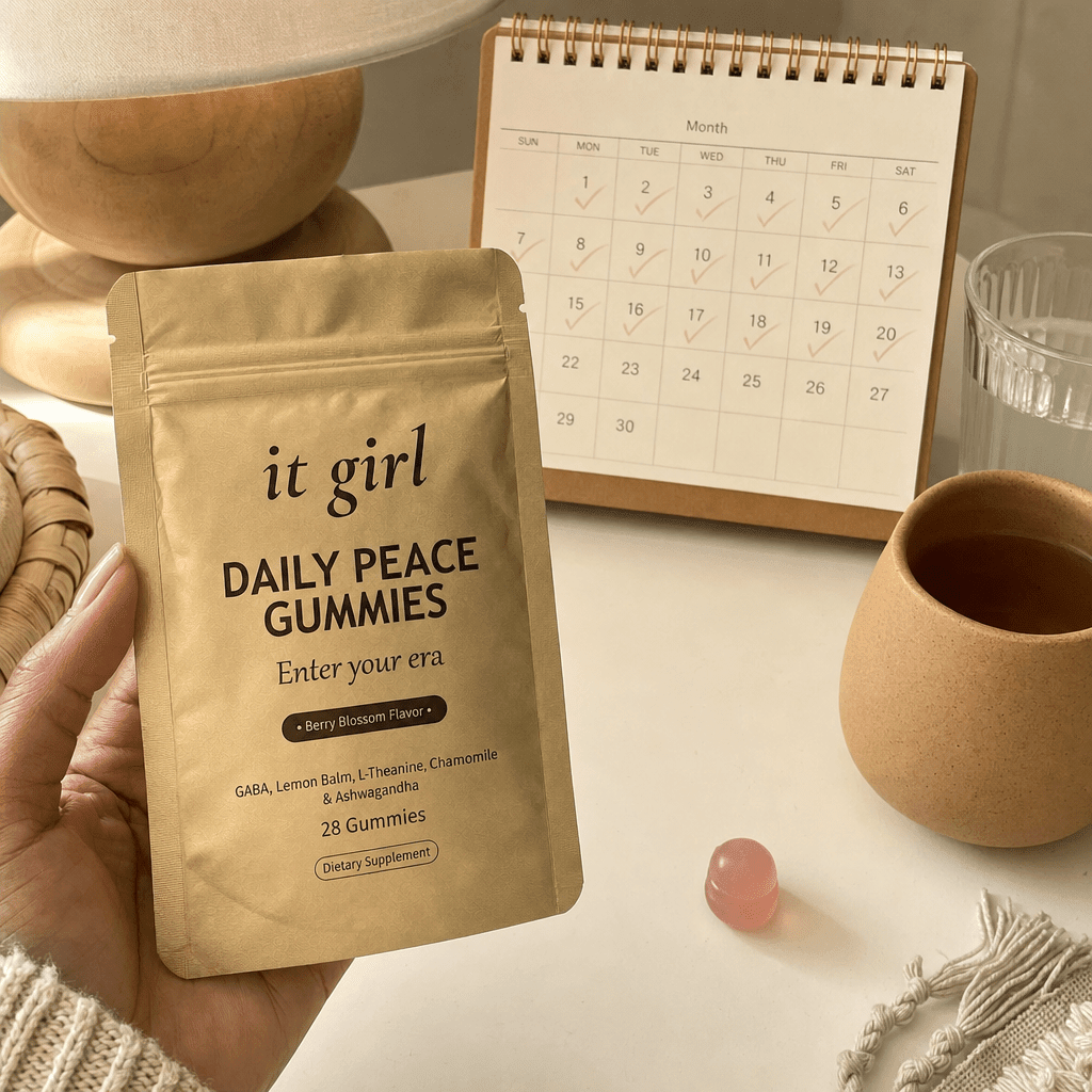 The palm-sized gold Daily Peace pouch beside a month calendar on a cream surface, a whole month of calm for about a dollar a day