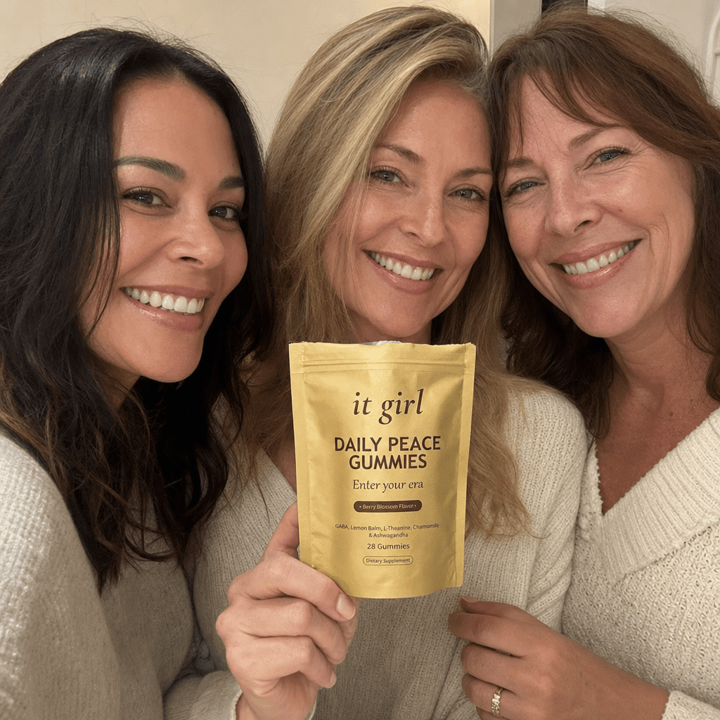 A relaxed group of women in warm daylight, one holding the real It Girl Daily Peace pouch, an everyday calm moment.