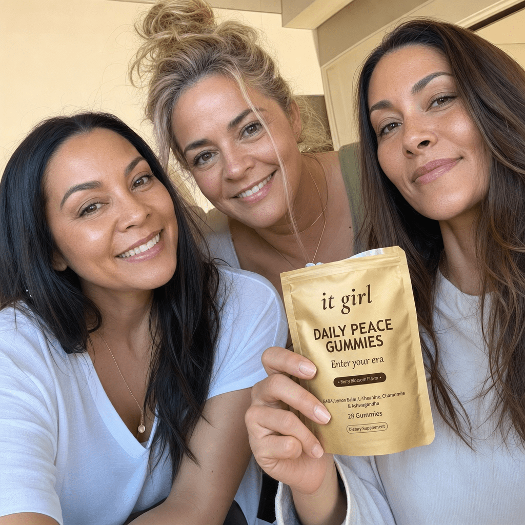 A relaxed group of women in warm daylight, one holding the real It Girl Daily Peace pouch, an everyday calm moment.