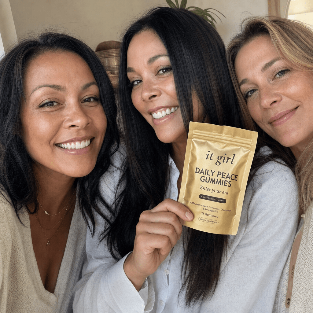 A relaxed group of women in warm daylight, one holding the real It Girl Daily Peace pouch, an everyday calm moment.