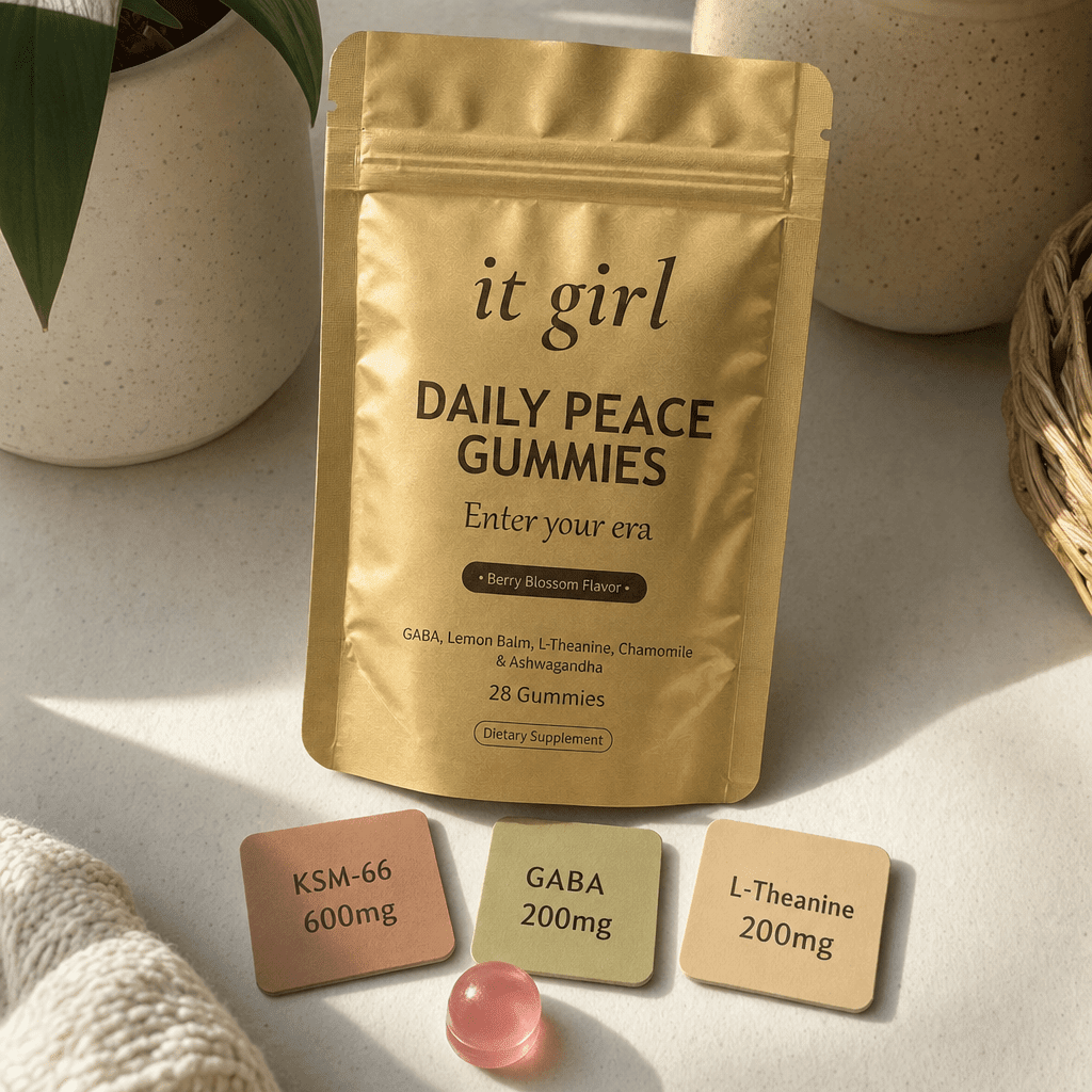 Three warm dose cards reading KSM-66 600mg, GABA 200mg, L-Theanine 200mg beside a single gummy and the gold Daily Peace pouch on a cream surface, two layers in one gummy