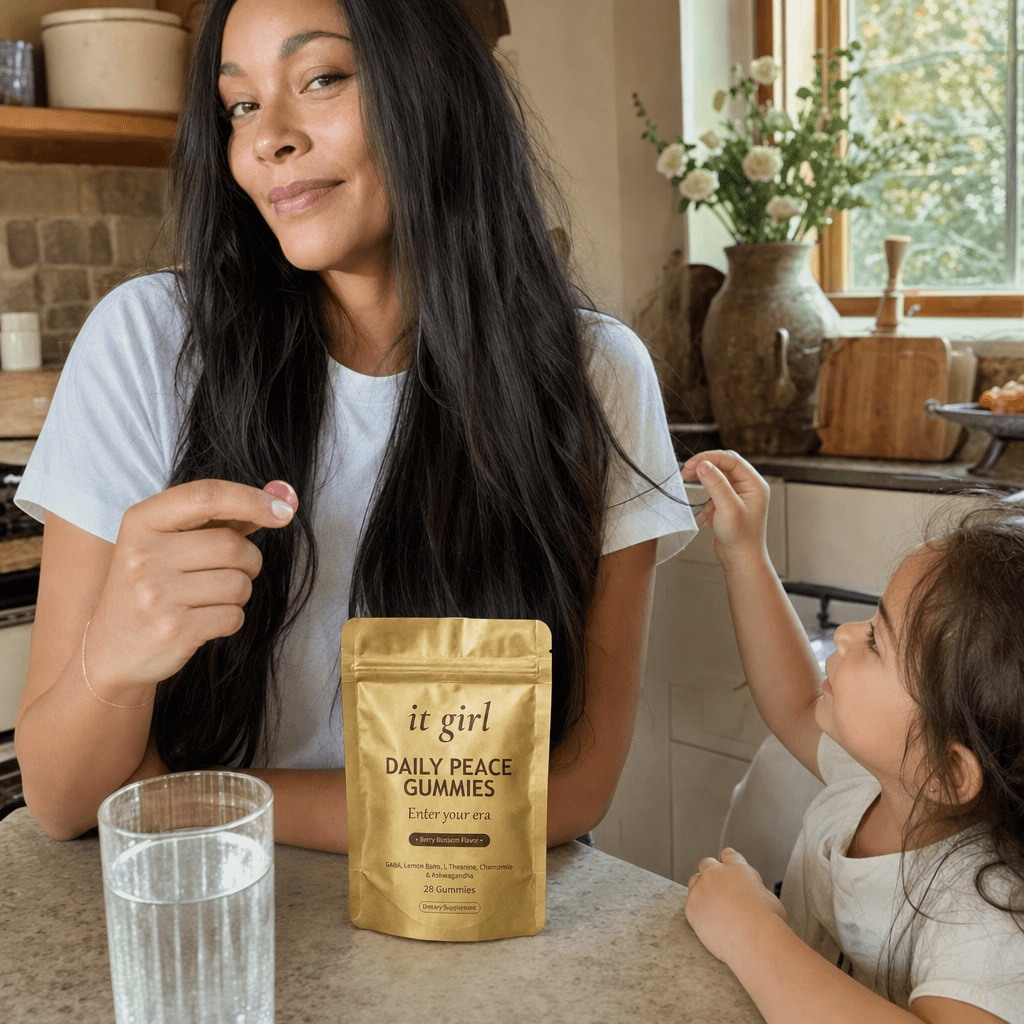 A calm, restored mother about forty steady in her warm afternoon kitchen with her child nearby, the gold Daily Peace pouch on the counter and a glass of water, no wine