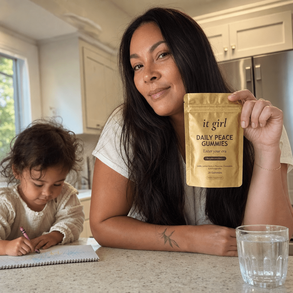 A calm, restored mother about forty steady in her warm afternoon kitchen with her child nearby, the gold Daily Peace pouch on the counter and a glass of water, no wine