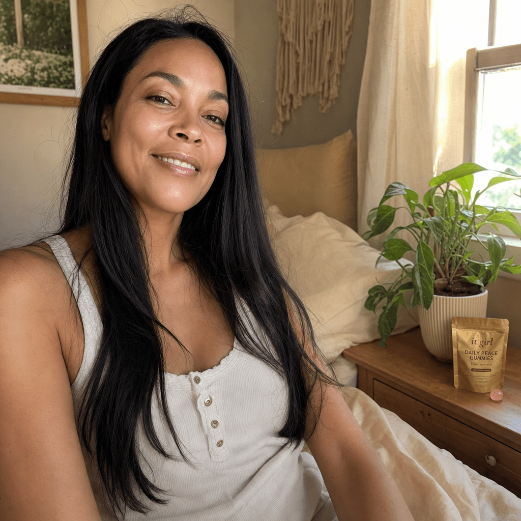 A woman waking calm and unhurried in soft morning light, the gold Daily Peace pouch resting on the nightstand