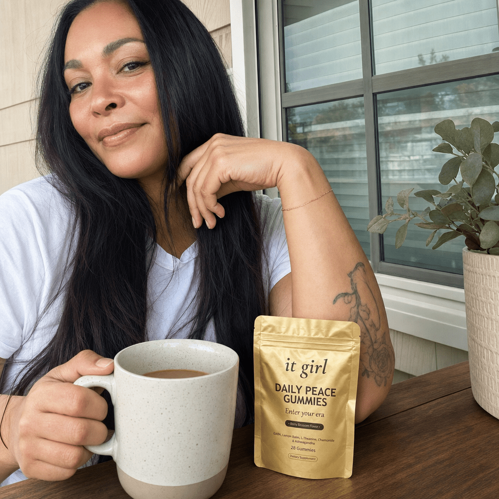 A woman calm and in command on a sunlit porch with a mug of coffee, the gold Daily Peace pouch resting nearby