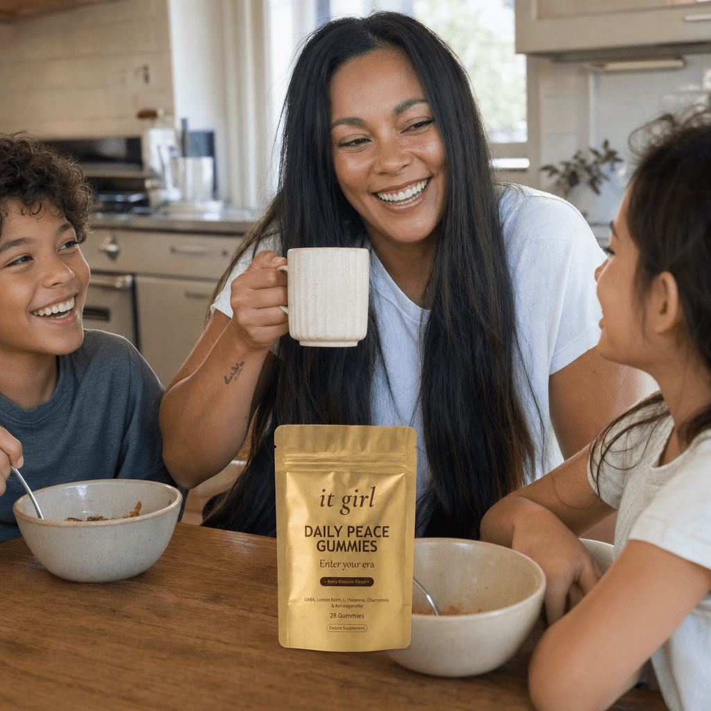 A mom fully present with her kids at a sunlit breakfast table, the It Girl Daily Peace pouch on the counter