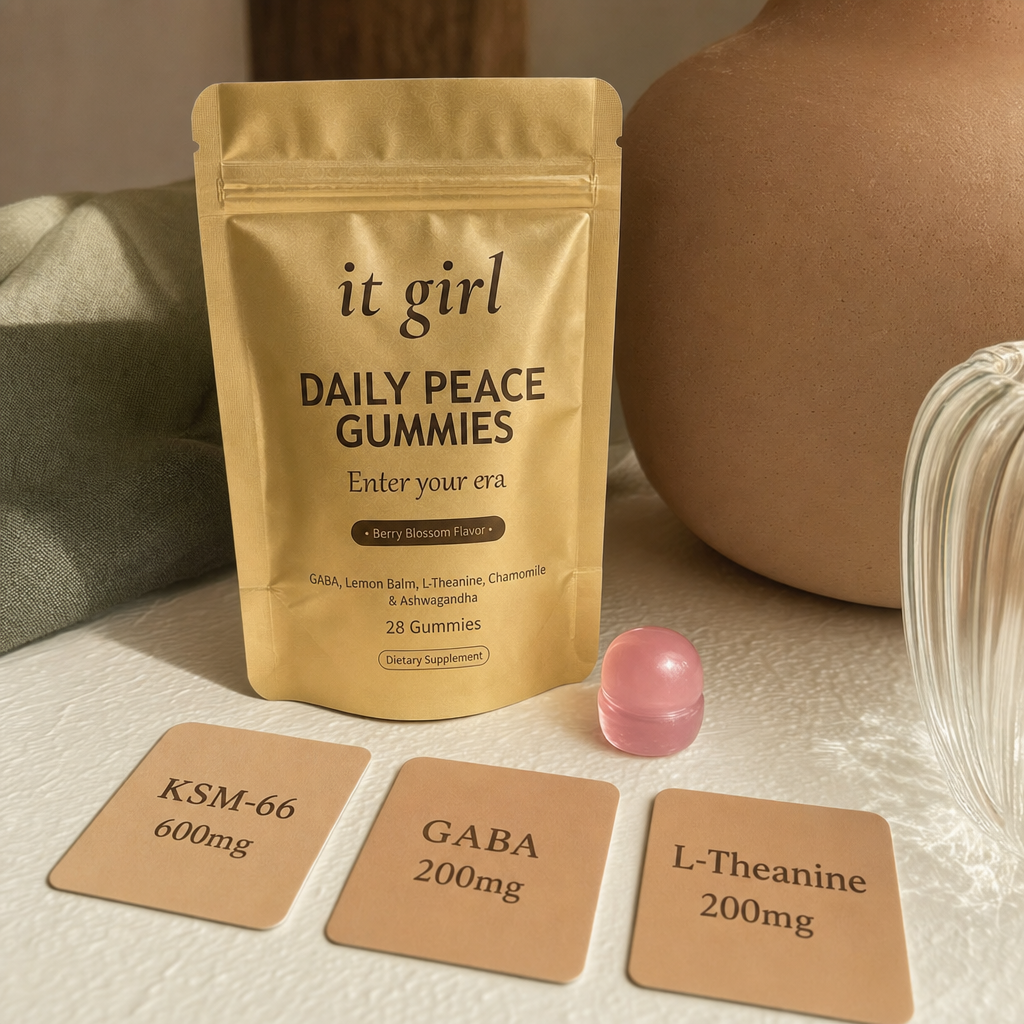 A single pink Daily Peace gummy beside three dose cards reading KSM-66 600mg, GABA 200mg, L-Theanine 200mg, with the gold pouch behind them, the studied dose