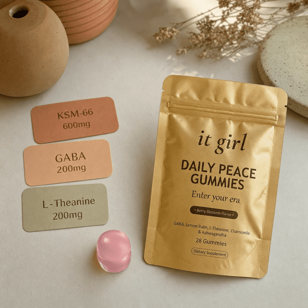 Three warm dose cards reading KSM-66 600mg, GABA 200mg and L-Theanine 200mg beside a single gummy and the gold Daily Peace pouch on a cream surface, the studied dose, no people