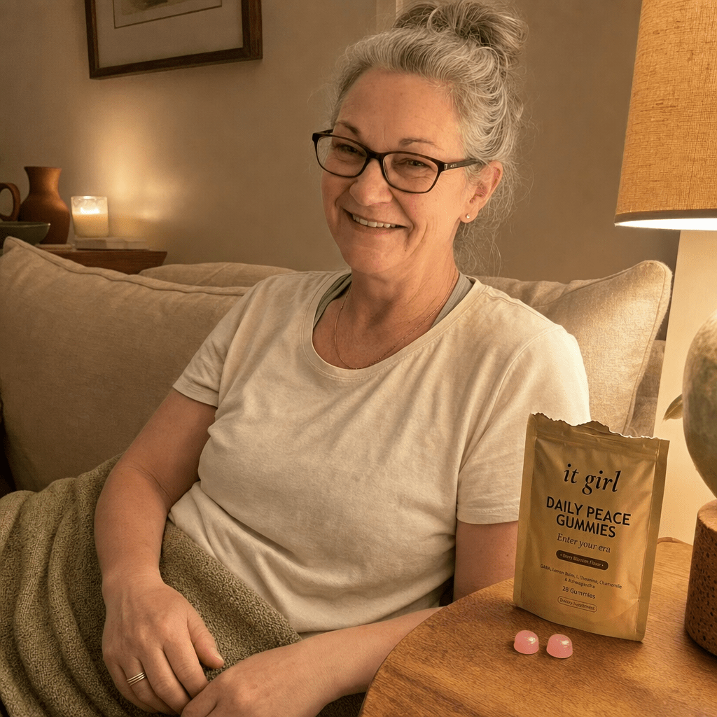 Cristina calm on her couch in the evening with the laptop closed and an open It Girl Daily Peace pouch nearby, watching instead of reaching, no wine glass