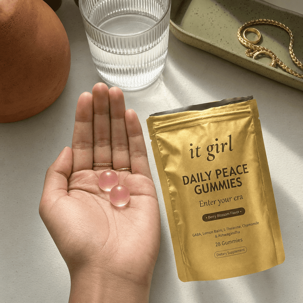 Open palm holding two Daily Peace gummies beside the opened gold pouch and a glass of water, the GABA plus L-Theanine signal
