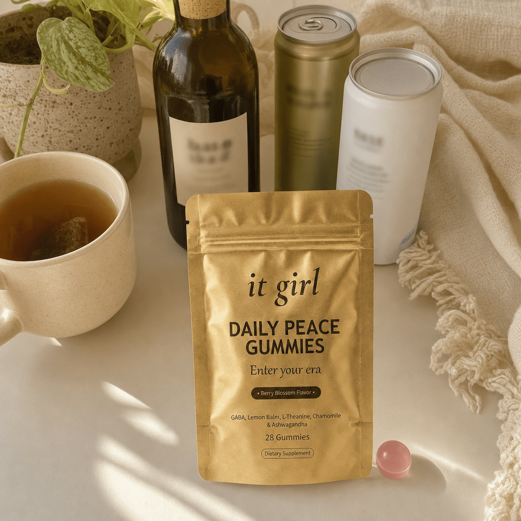 Cream counter of the abandoned swaps pushed aside, a corked alcohol-free wine bottle, an adaptogen can, sparkling water, hot tea, the gold Daily Peace pouch chosen forward
