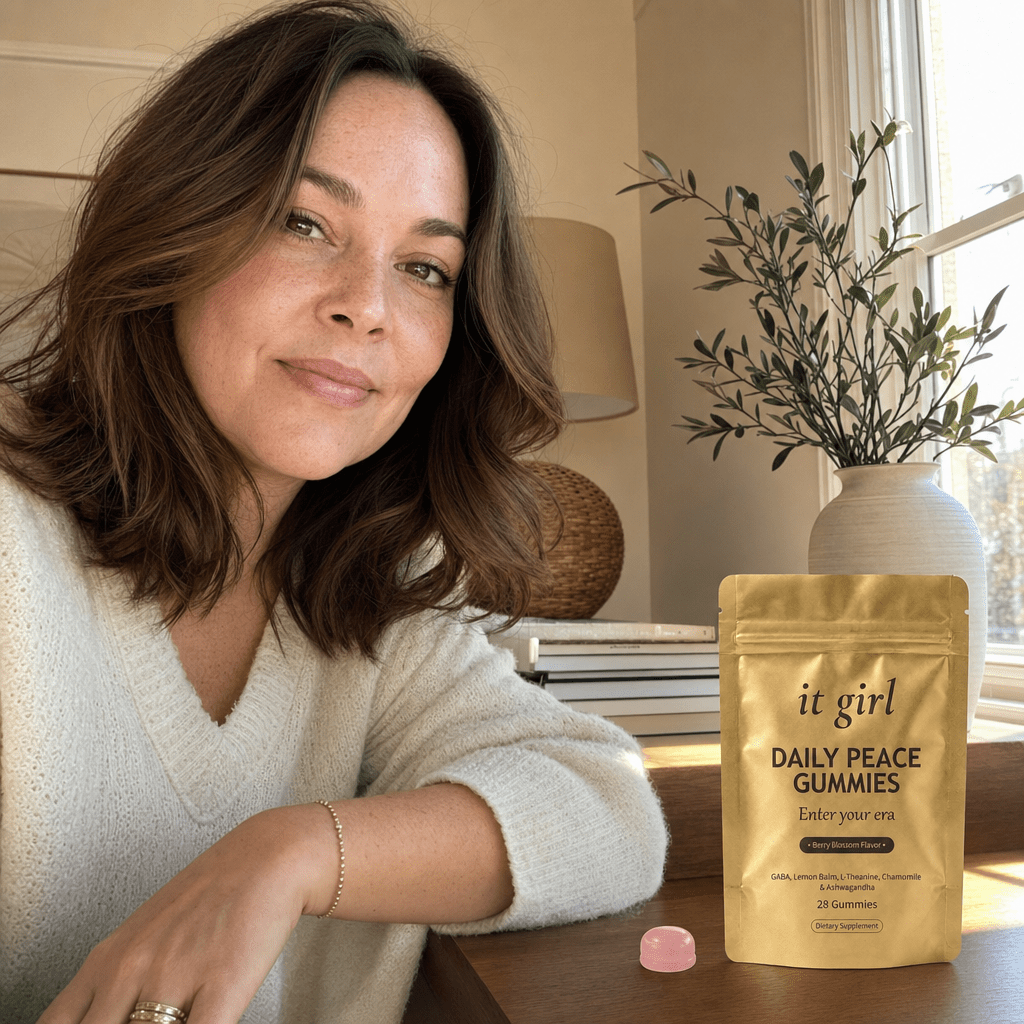 Restored late-thirties woman in soft warm light with a relaxed unclenched jaw and a calm open expression, the years of self-blame lifting, hand resting easy near a gold Daily Peace pouch